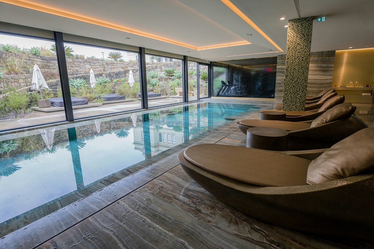 SPA hotel manager using tablet with multilingual AI concierge software interface