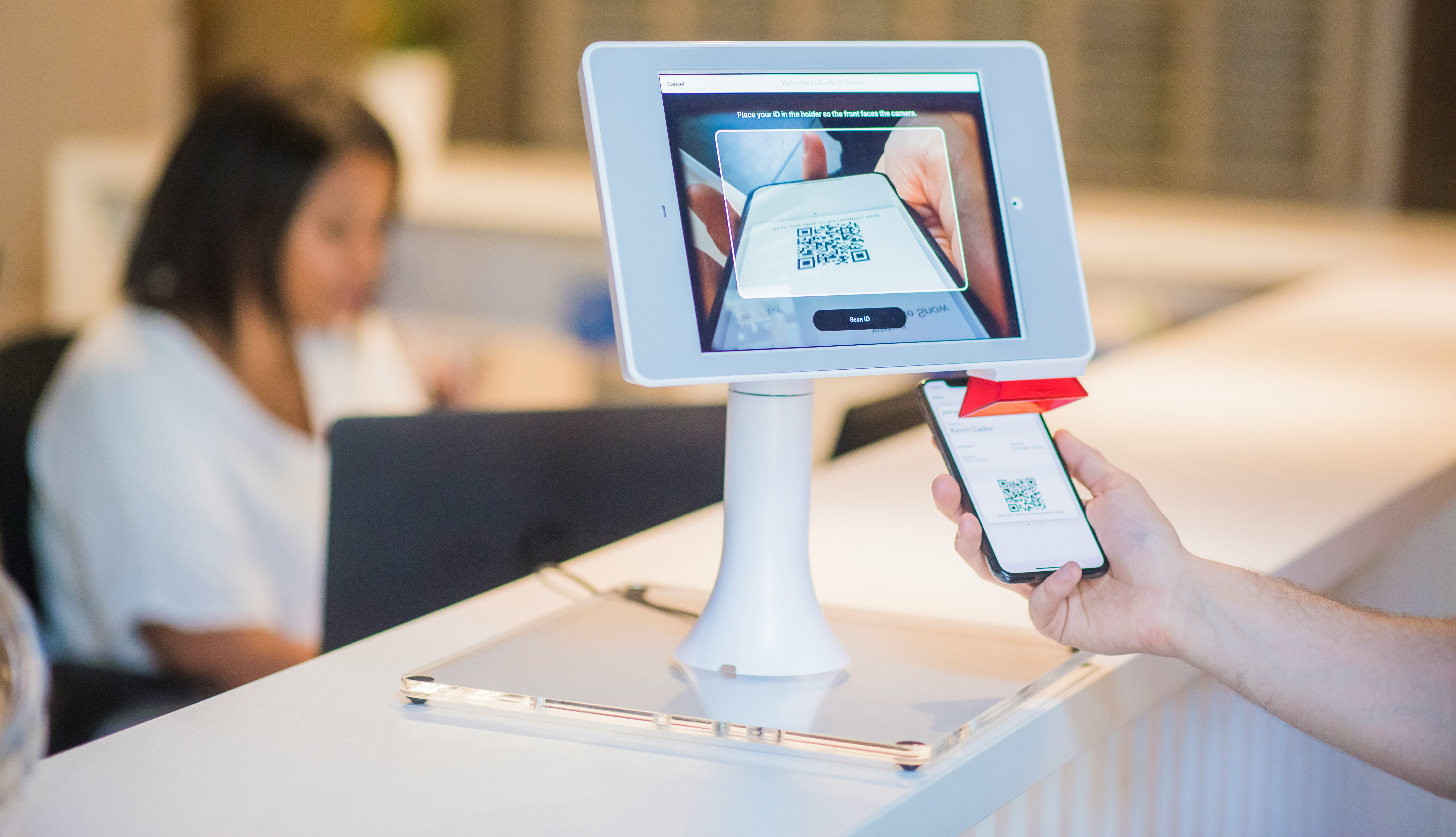 Guest using self-service digital kiosk at hotel entrance