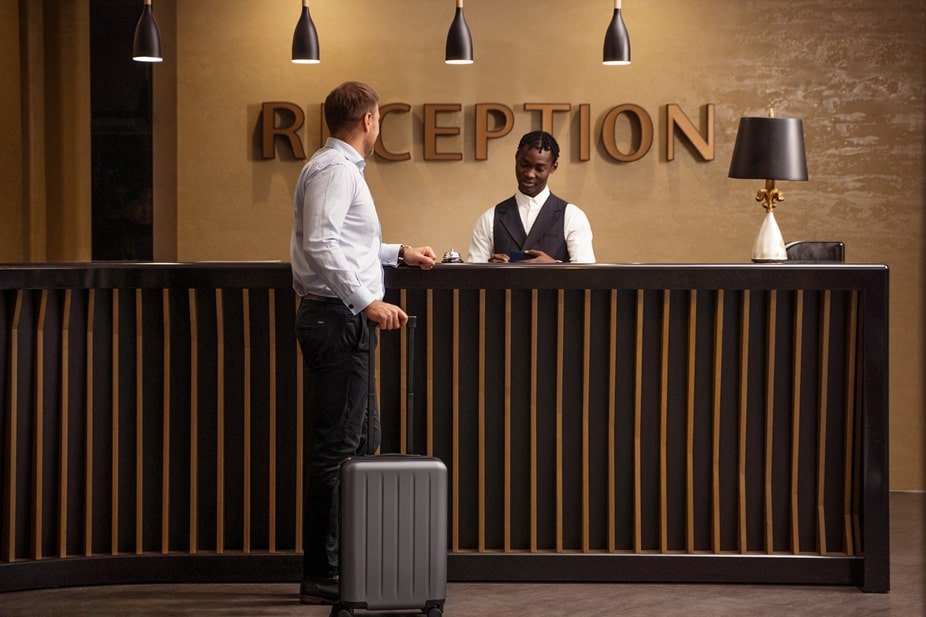 Modern SPA hotel reception with digital check-in kiosk and warm ambient lighting